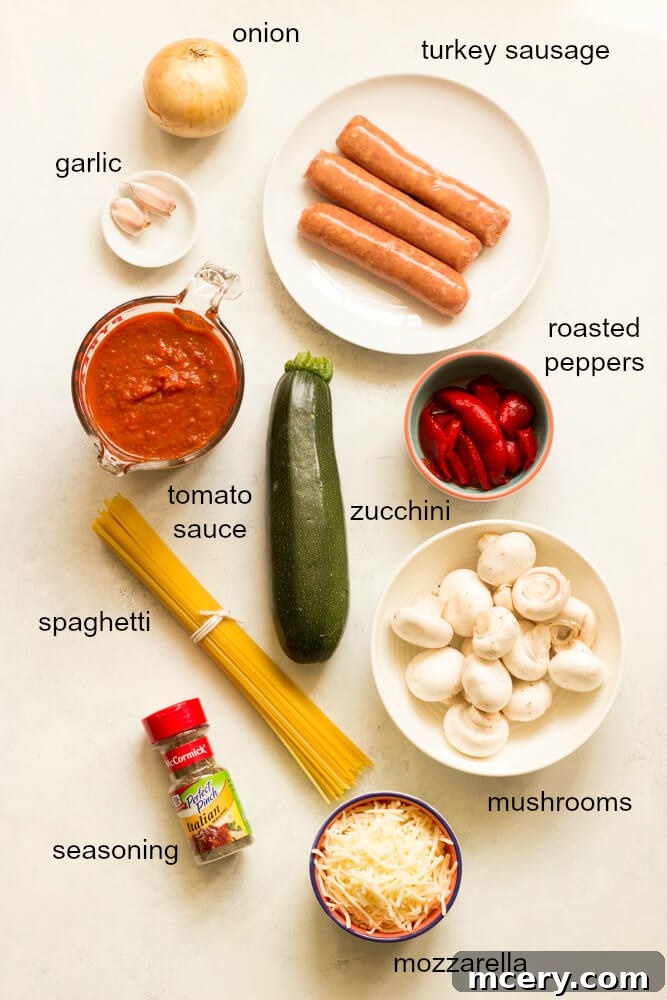 Overhead view of ingredients for a delicious spaghetti zucchini bake, neatly arranged on a white surface.