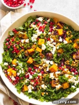 A beautifully composed image of a festive Kale Salad with Cranberries and Feta in a pristine white bowl, showcasing its vibrant fall colors and inviting textures. This healthy side dish is perfect for Thanksgiving and holiday meals.