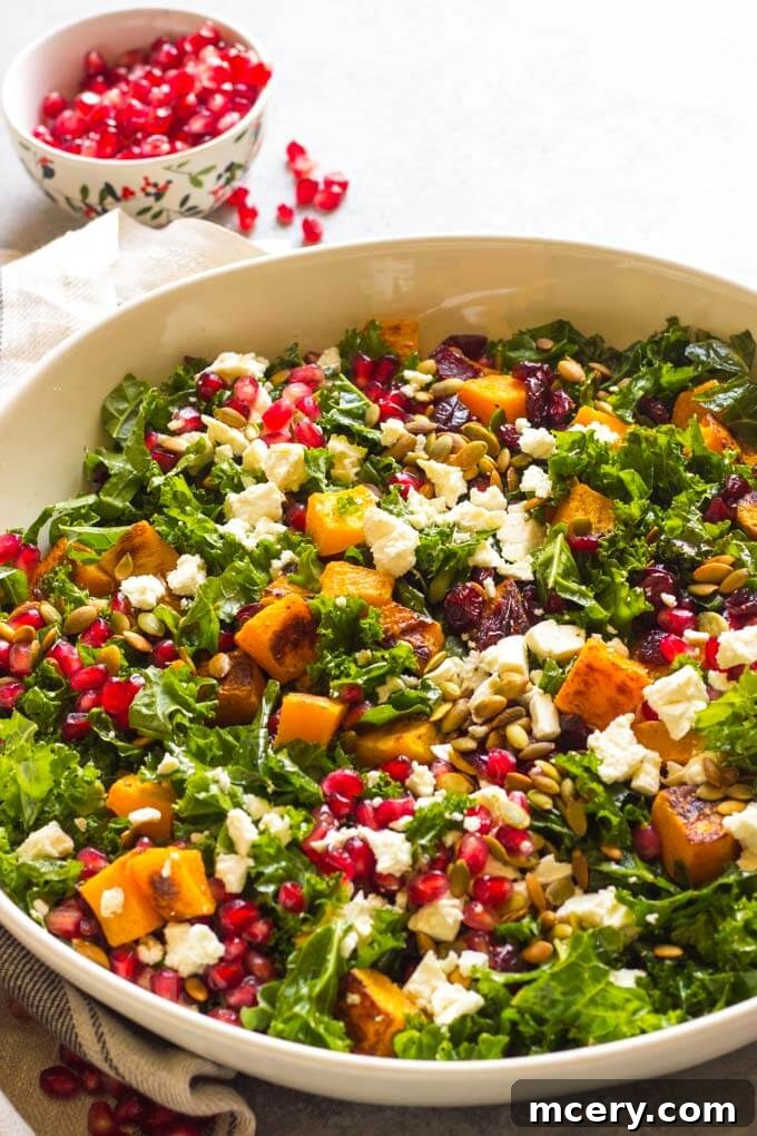 Sweet-Tart Kale and Cranberry Salad 8 A stunning side view close-up of the fully assembled kale salad with cranberries and feta, artfully arranged in a white bowl, showcasing layers of texture and vibrant color. The dressing lightly coats each ingredient.