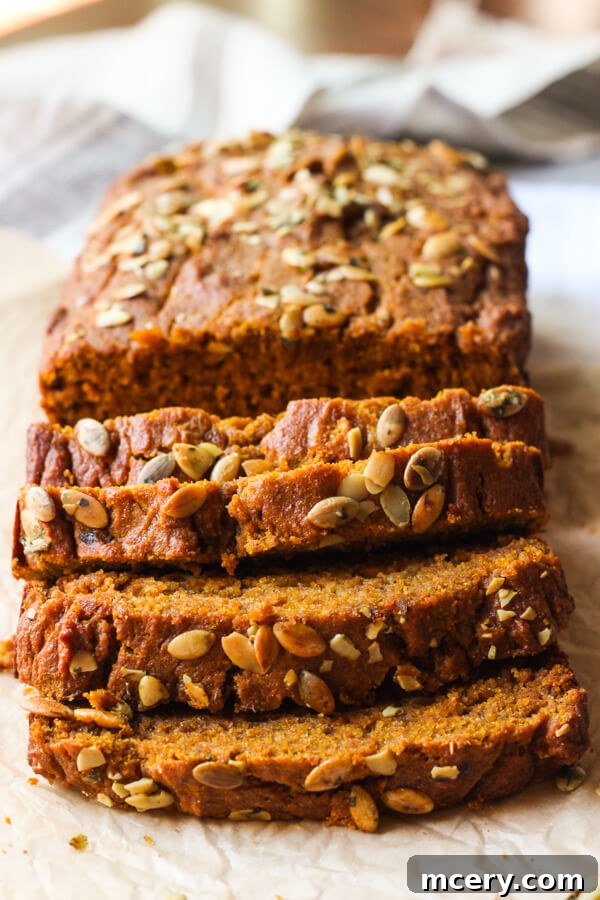Clean Eating Pumpkin Loaf 8 Close up of a thick slice of healthy pumpkin bread, showcasing its incredibly moist, tender, and evenly spiced interior.