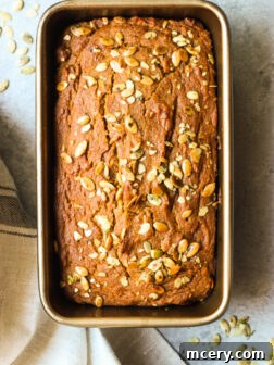 Close up of pumpkin bread in loaf pan, freshly baked and ready to enjoy.