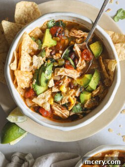 A bowl of flavorful turkey tortilla soup with rich broth and toppings.