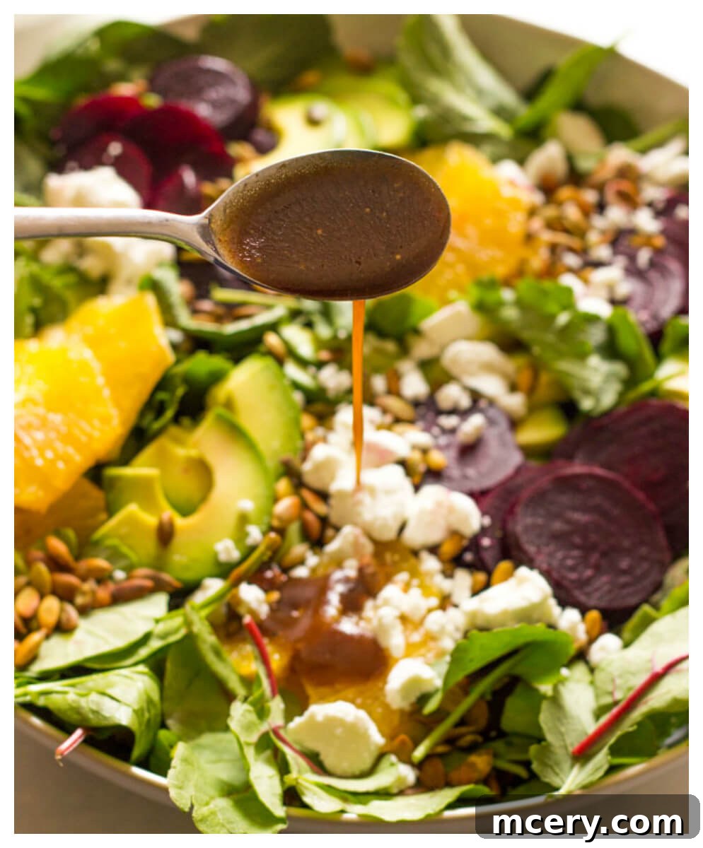 Vibrant Roasted Beet and Avocado Salad 8 Close up of beet salad dressing poured over roasted beet salad