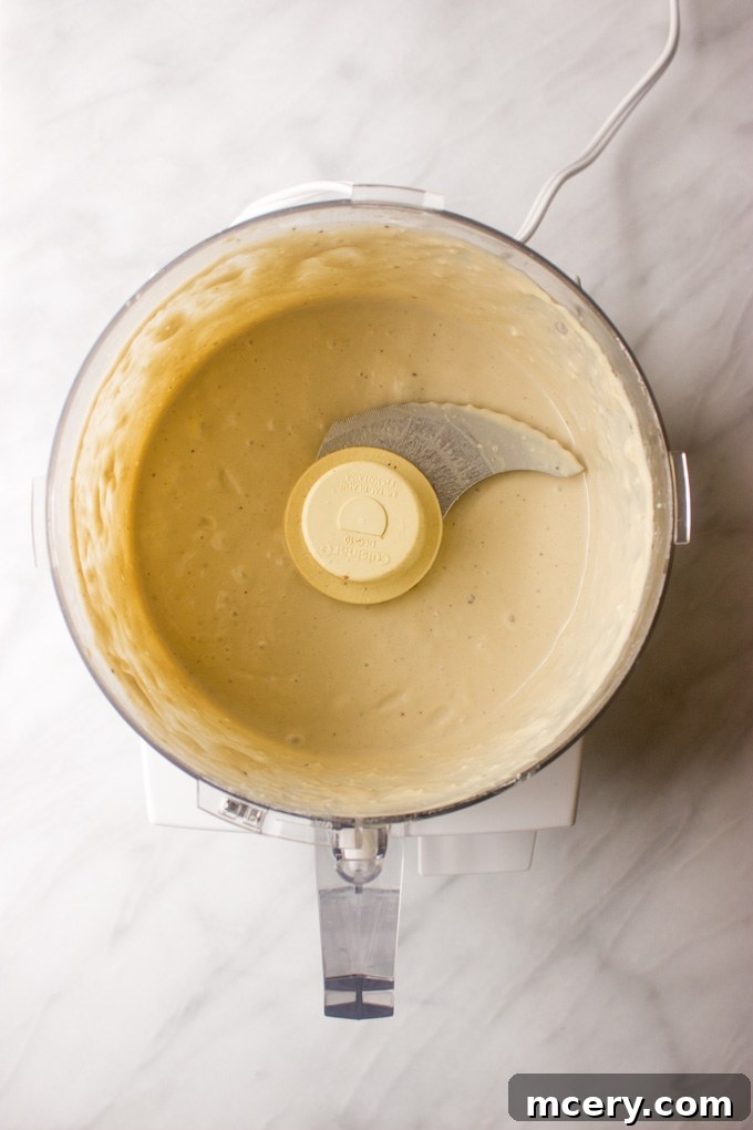 Lush Avocado Caesar 5 The smooth and creamy Greek yogurt Caesar dressing after being blended in a food processor, ready for refrigeration.