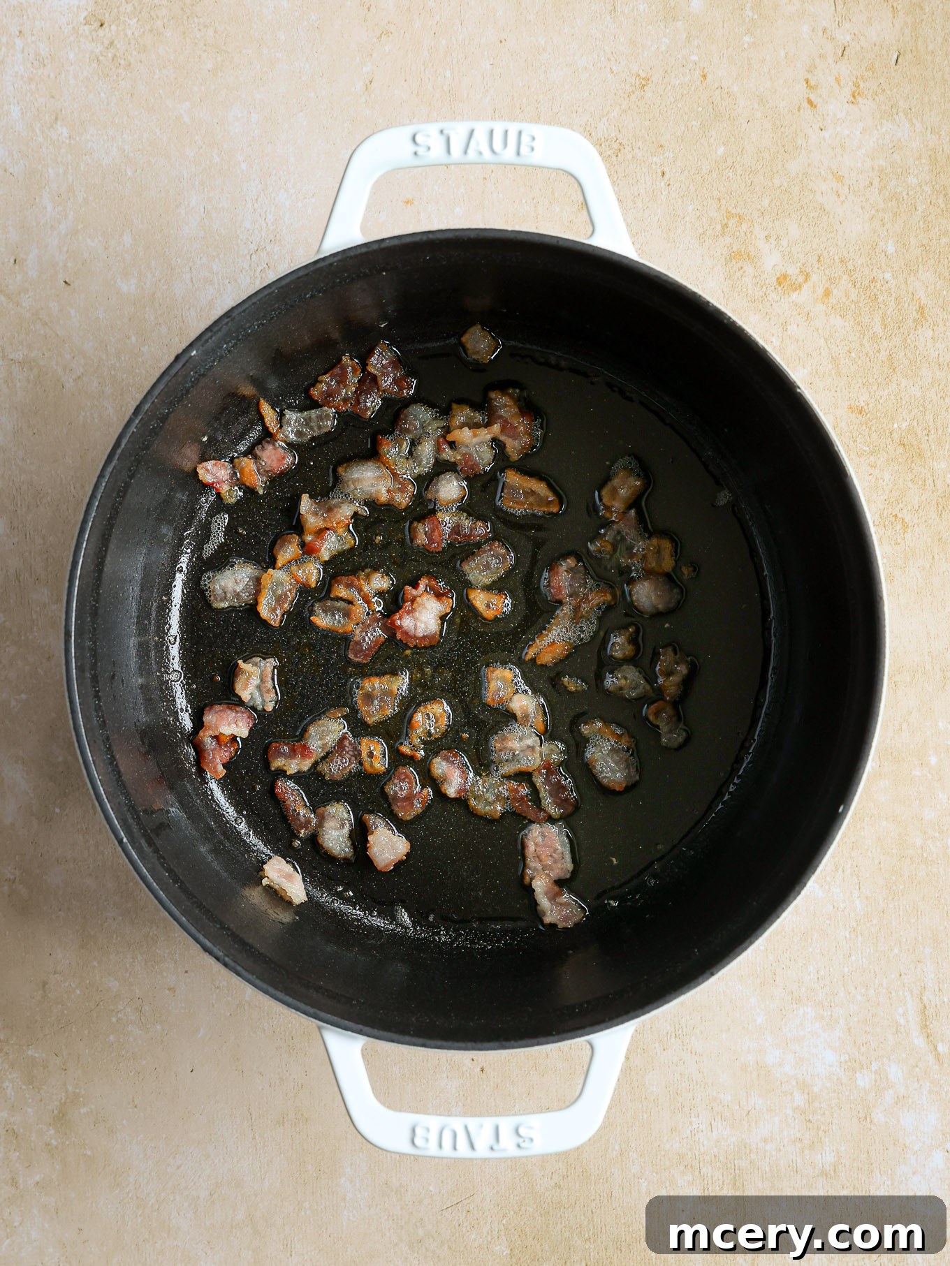 Velvety Scallop Chowder 4 Crispy cooked bacon in a Dutch oven, with rendered fat at the bottom.