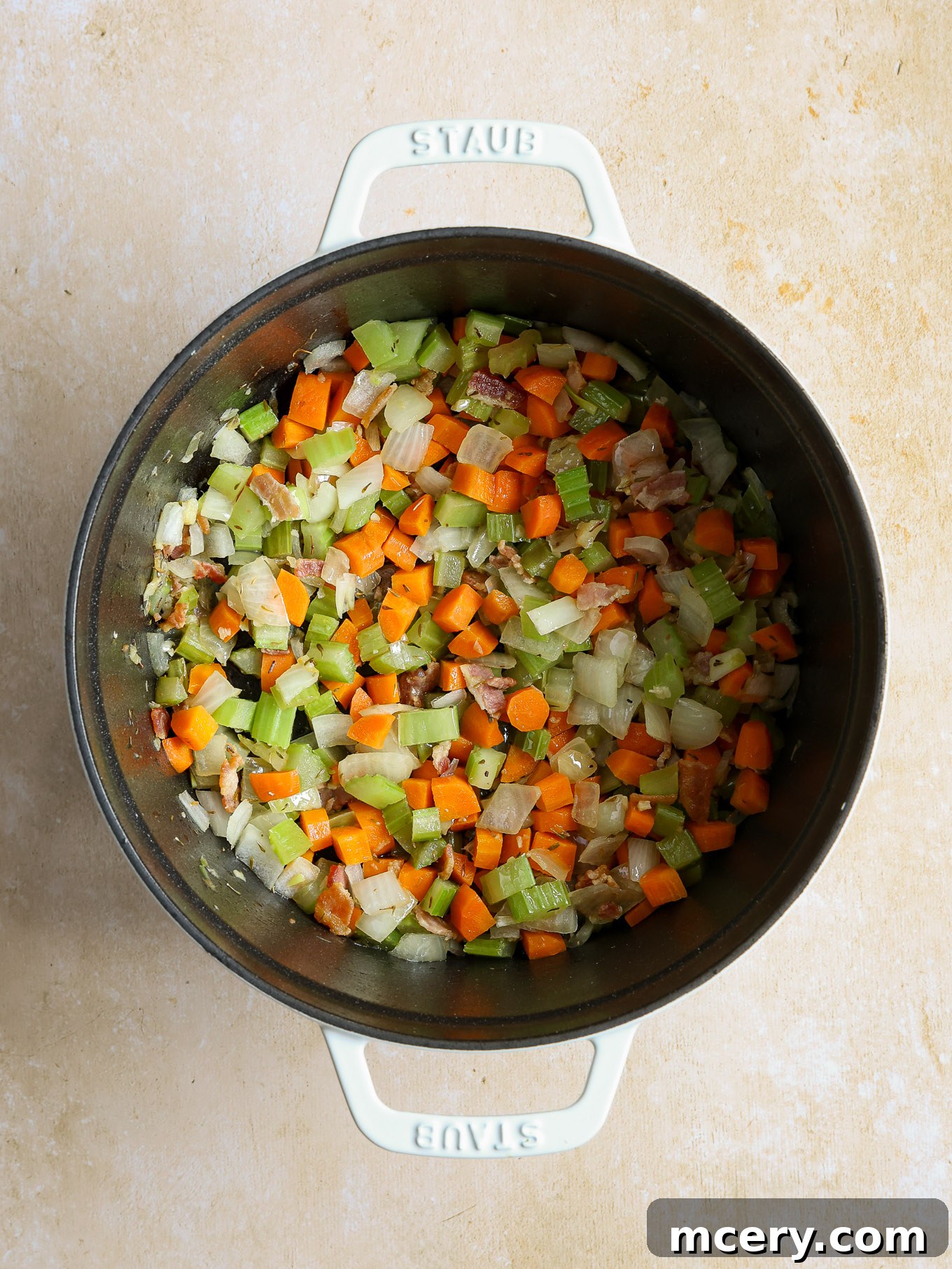 Velvety Scallop Chowder 5 Sautéed onions, carrots, and celery cooking with garlic in a Dutch oven.