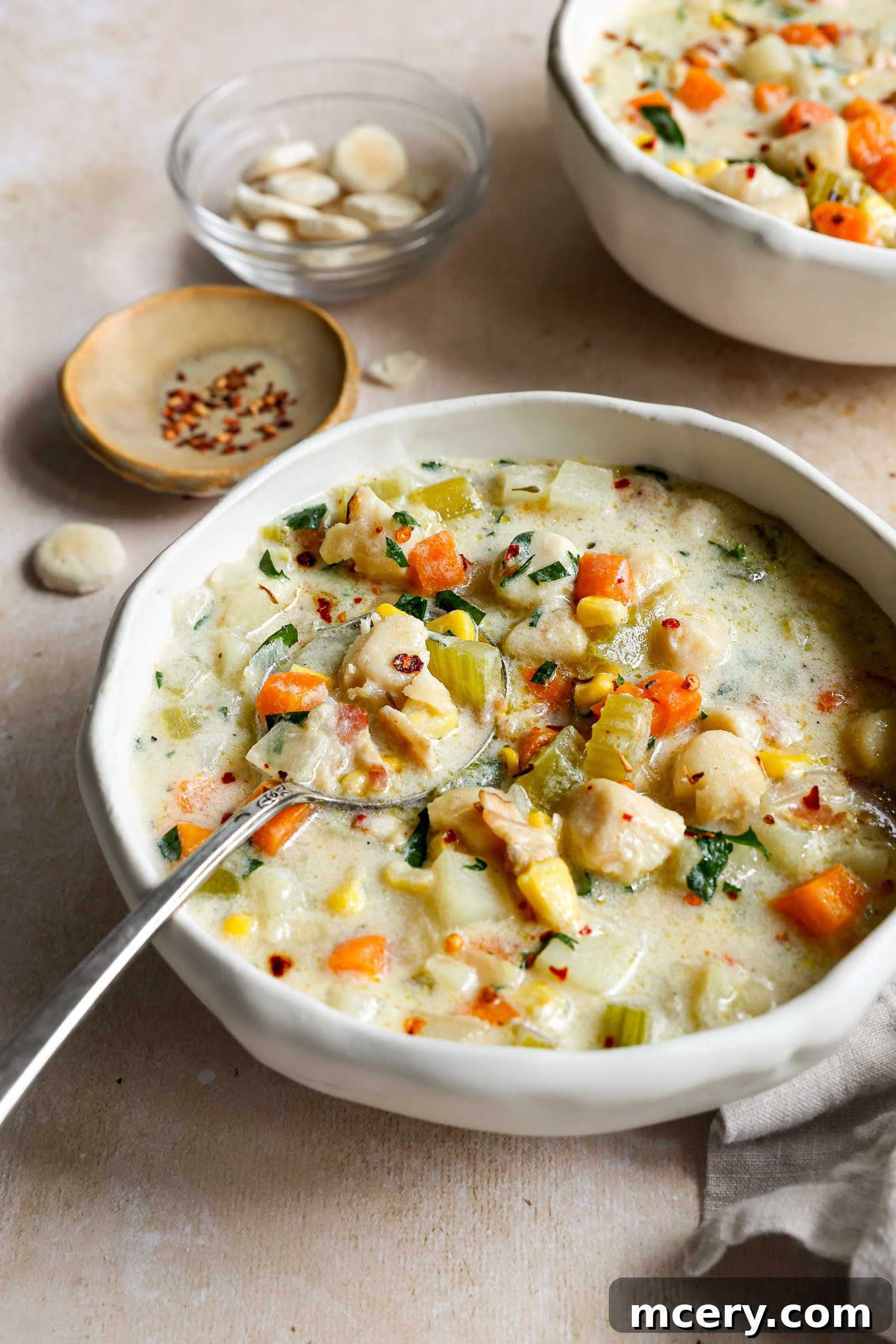 Velvety Scallop Chowder 10 A close-up shot of creamy scallop chowder in a bowl, showing the texture and ingredients.
