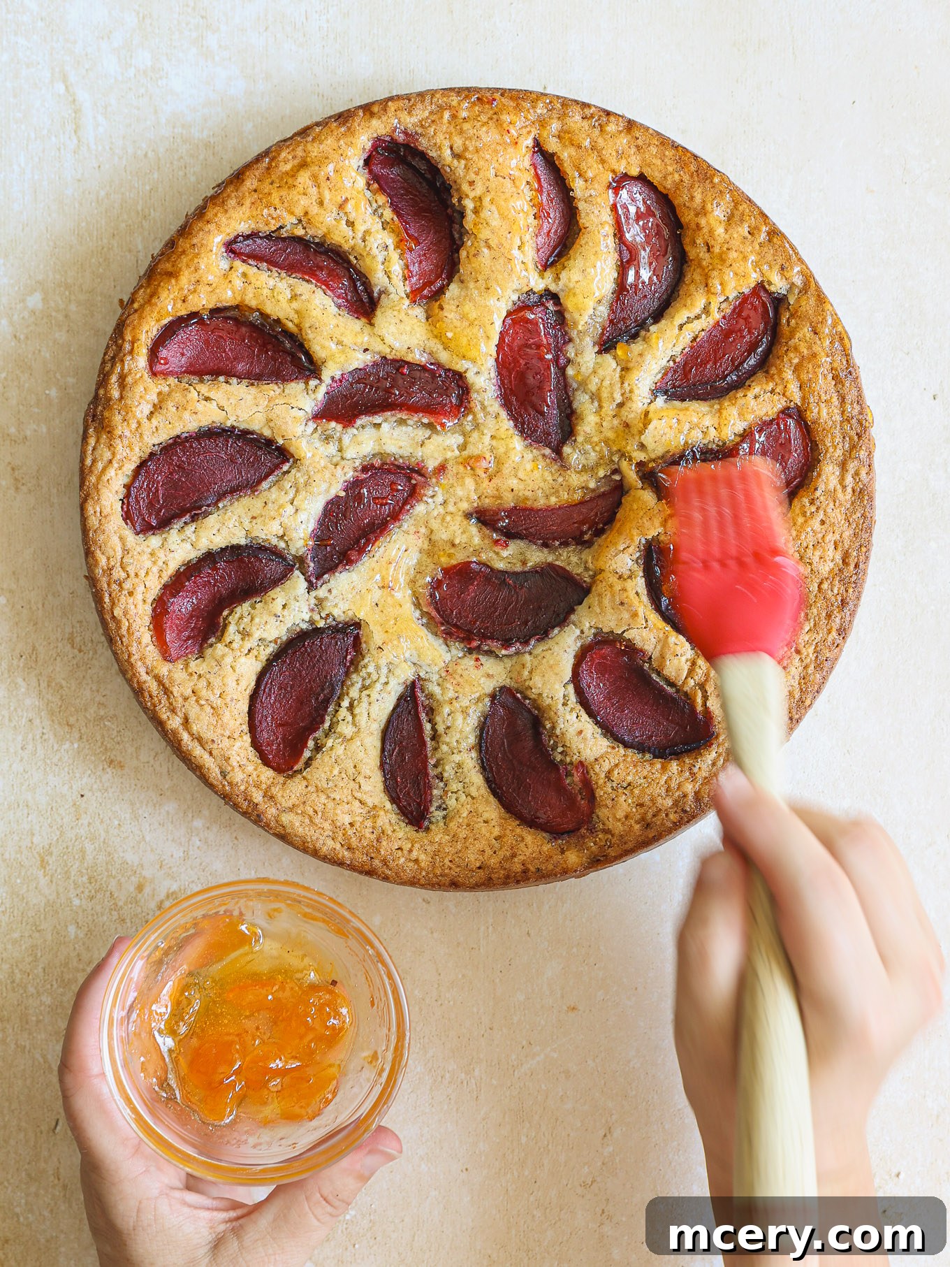Classic Plum Torte 11 Apricot jam being brushed over the warm, baked torte.