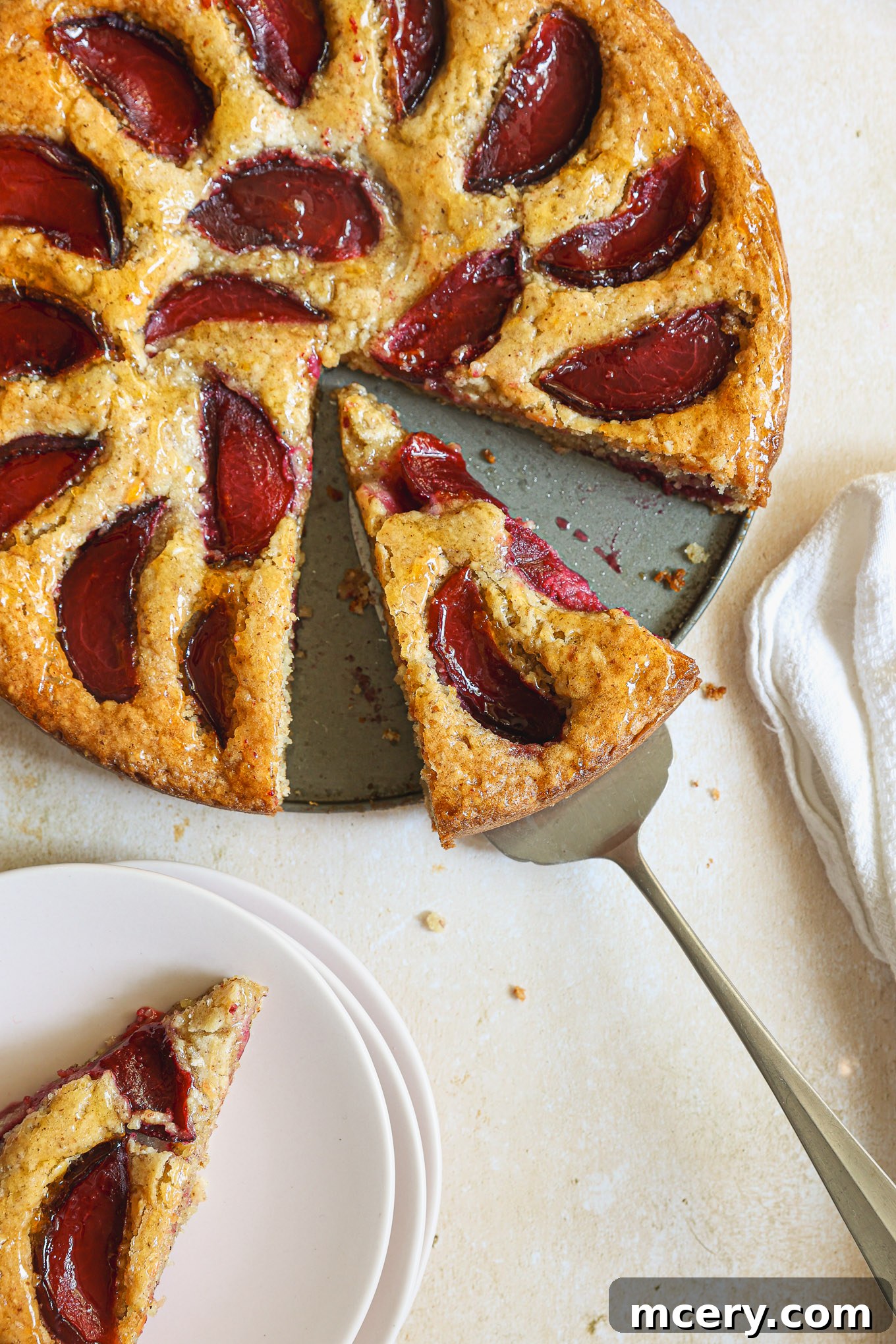 Classic Plum Torte 12 Close up view of a sliced plum torte, showing caramelized plums.