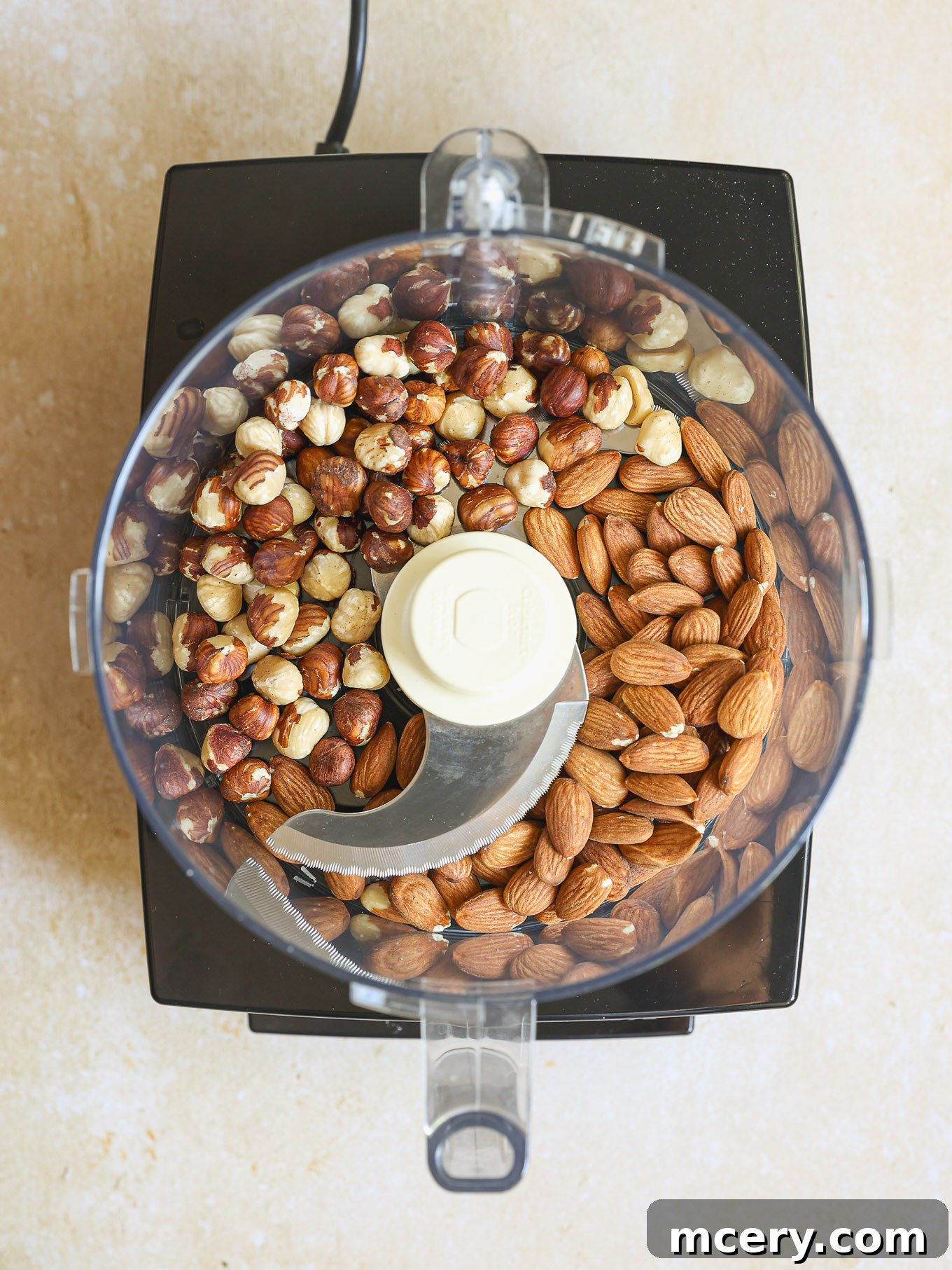 Classic Plum Torte 4 Whole almonds and hazelnuts in a food processor bowl.