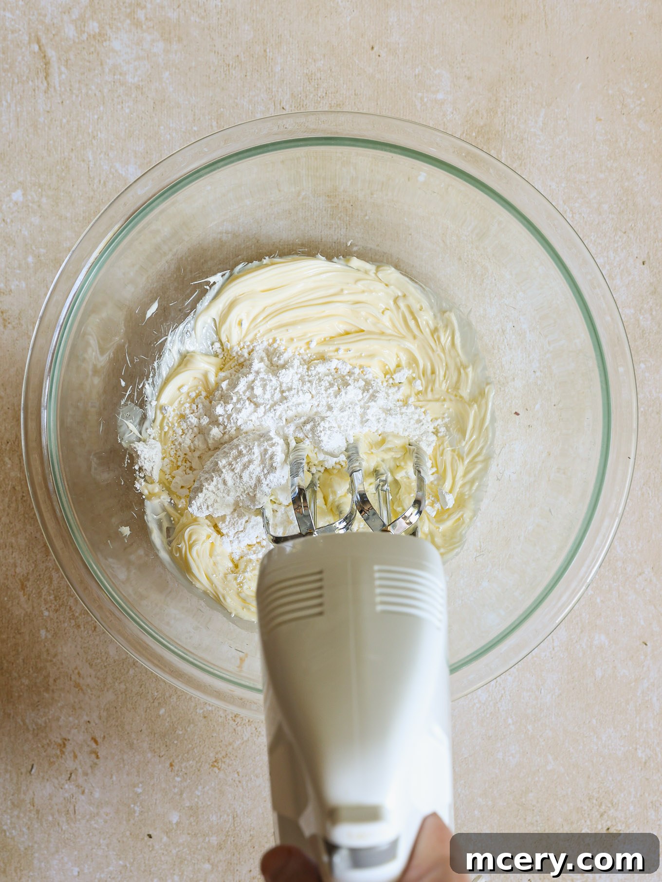 Classic Plum Torte 6 Creamed butter and confectioners' sugar in a glass mixing bowl.