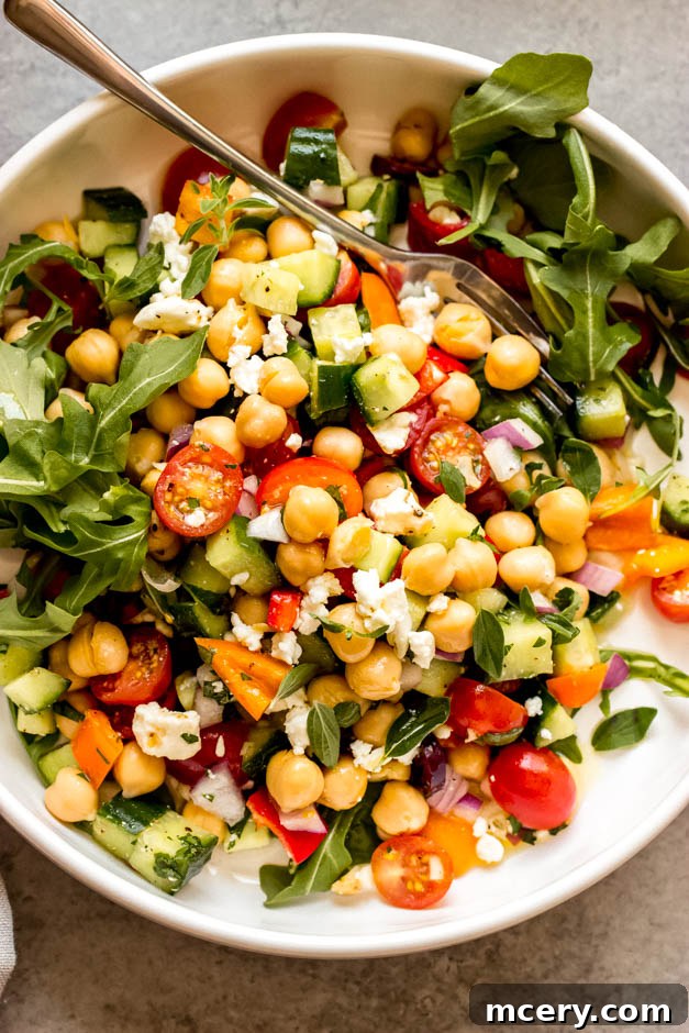 Vibrant Mediterranean Chickpea Salad 7 Close-up shot of Greek Chickpea Salad in a white bowl, emphasizing the texture and freshness of the ingredients, perfectly dressed and ready to eat.