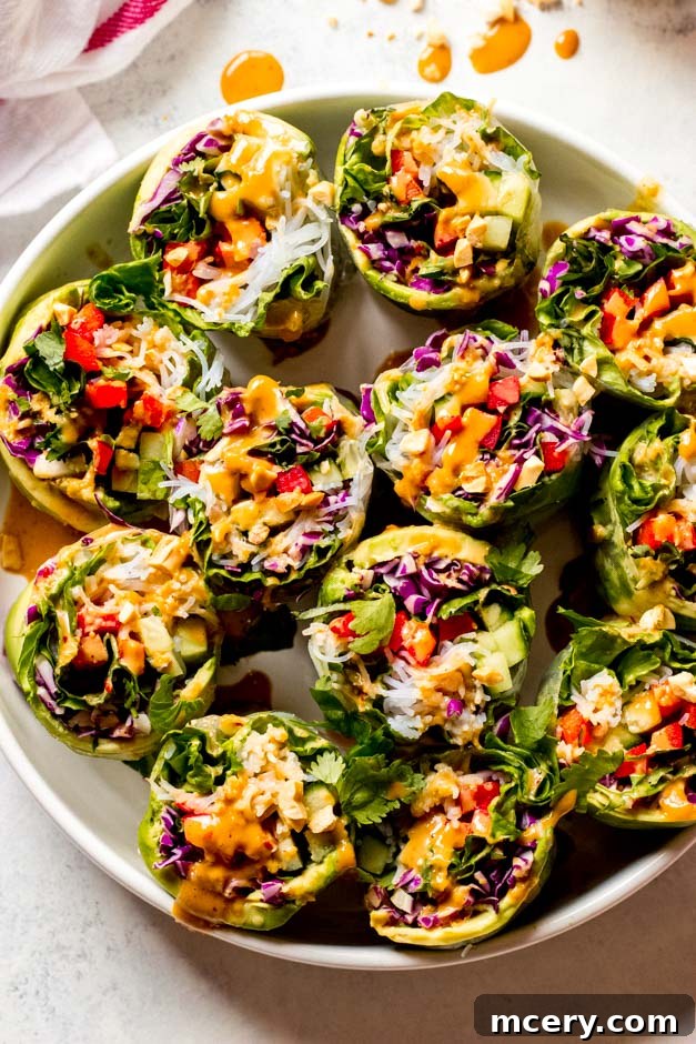 Easy Homemade Veggie Rolls 8 Close-up of vibrant vegetable rice paper rolls, showcasing the colorful fillings and delicate wrappers, presented on a white serving platter.