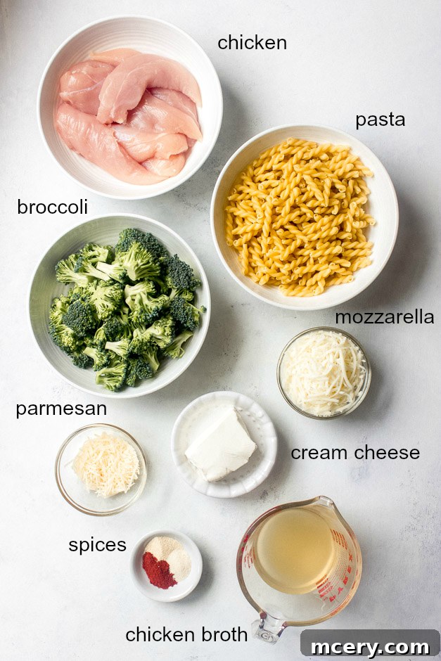 Creamy Chicken Broccoli Pasta Bake 4 Ingredients laid out for a chicken and broccoli pasta bake, highlighting fresh produce and cheeses.