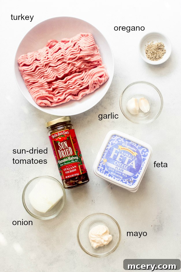 Sun-Kissed Mediterranean Turkey Burgers 3 Collection of ingredients for Mediterranean turkey burgers including ground turkey, sun-dried tomatoes, feta, onion, and herbs
