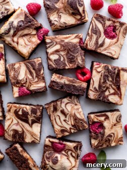 Fudgy Raspberry Cheesecake Swirl Brownies ready to be cut