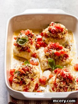 Side view baked cod with panko, lemon butter, and fresh tomato bruschetta