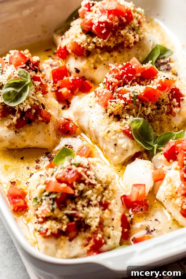 Crispy Panko Cod Bake 3 Close up view of crispy baked cod with a golden Panko crust, topped with fresh tomato bruschetta