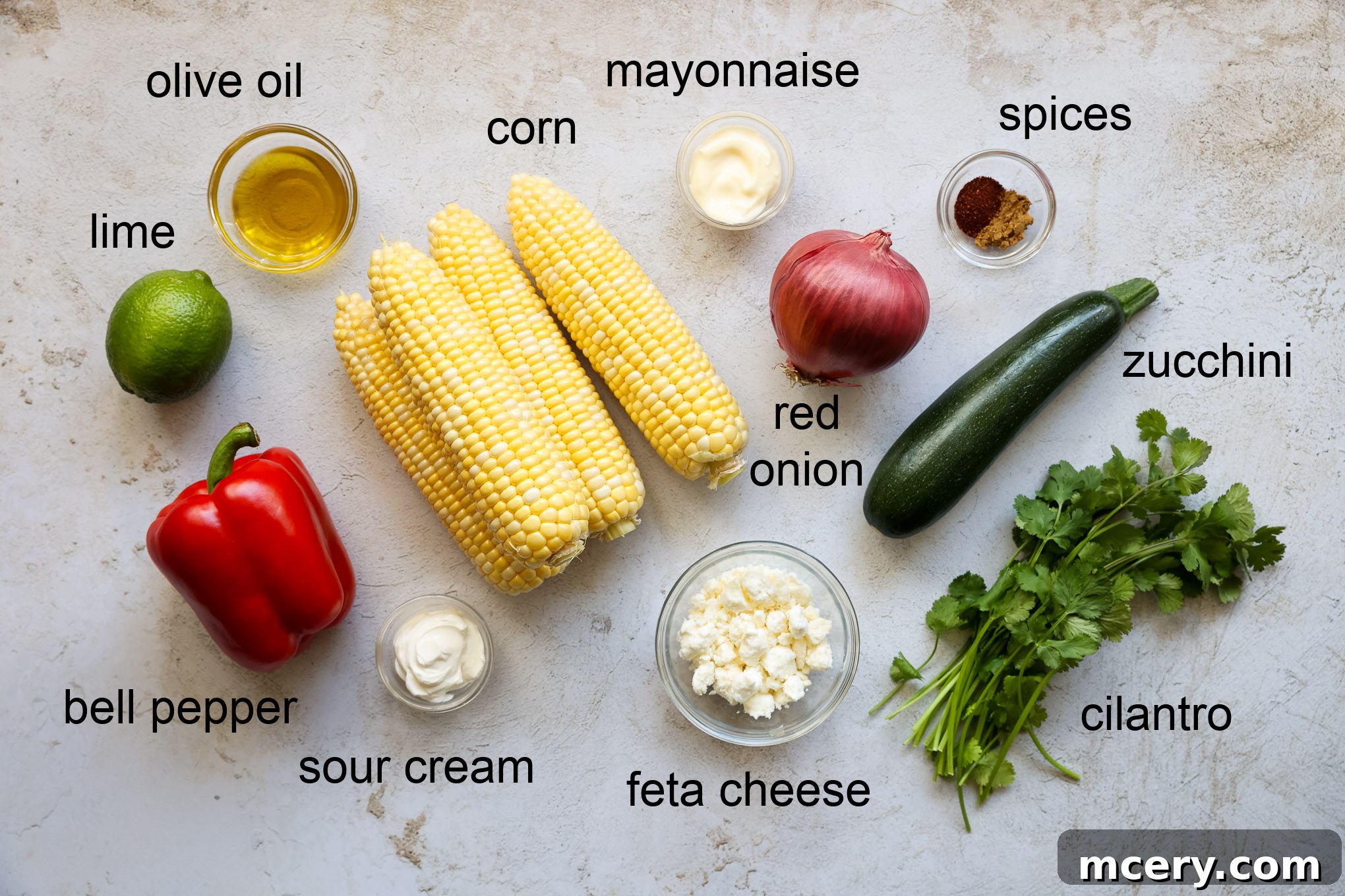 Vibrant Zucchini Corn Medley 3 A spread of fresh ingredients for corn and zucchini salad, including corn on the cob, zucchini, bell pepper, and cilantro.
