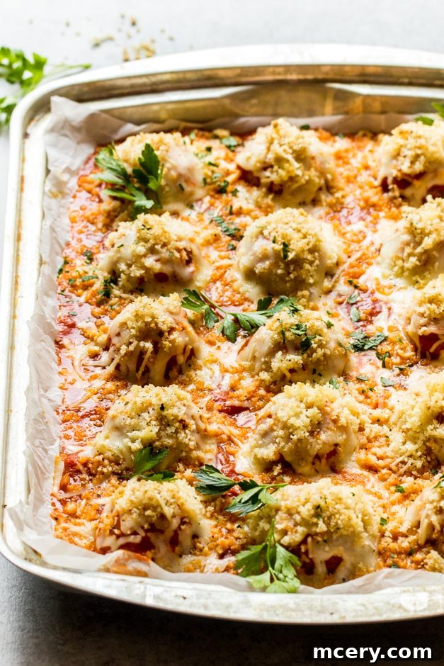 Chicken Parm Meatballs 3 Golden brown parmesan chicken meatballs simmering in marinara sauce