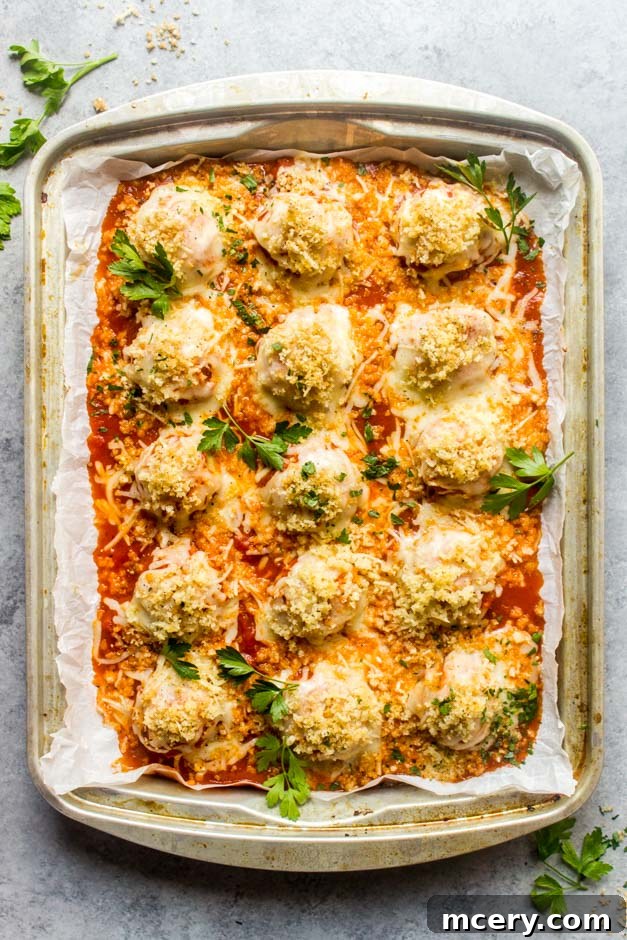 Chicken Parm Meatballs 9 Overhead shot of chicken meatballs with parmesan and garlicky crumbs, garnished with parsley