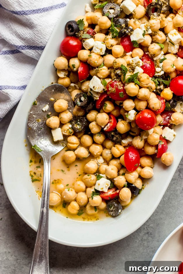 Mediterranean Sunshine Chickpea Salad 7 Close-up of a refreshing Mediterranean chickpea salad, showcasing feta, tomatoes, olives, and herbs.