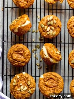 Healthy pumpkin muffins with cream cheese filling on a cooling rack