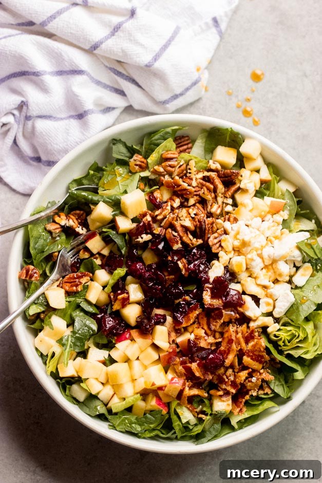 Vibrant Apple Spinach Medley 7 Close-up view of the chopped spinach apple salad, highlighting the textures of spinach, apple pieces, bacon, and goat cheese.