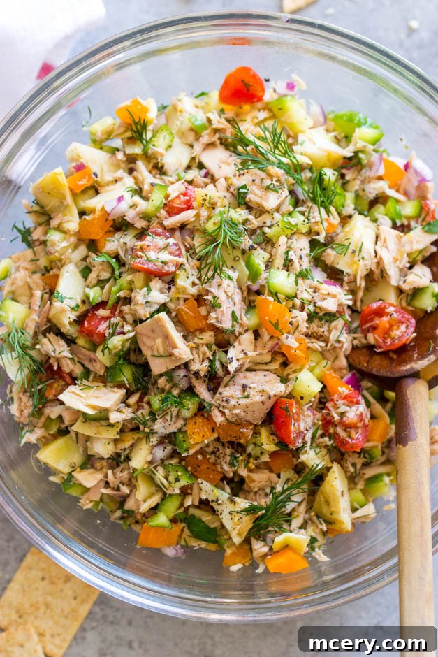 Sun-Kissed Mediterranean Tuna Salad 2 Close up view of a vibrant Mediterranean tuna salad packed with fresh vegetables.