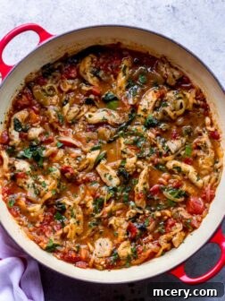 creamy tomato chicken recipe with spinach, herbs, and canned tomatoes.