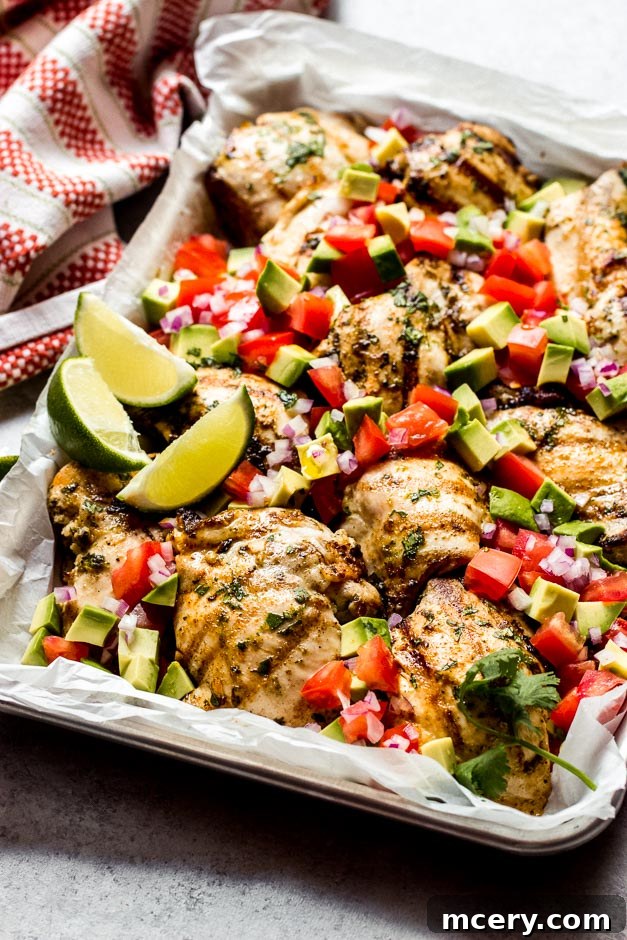 Fresh & Fast: Cilantro Lime Chicken with Creamy Avocado Salsa 6 Side view of perfectly grilled cilantro lime chicken, garnished with fresh cilantro and lime wedges, next to a bowl of avocado salsa.