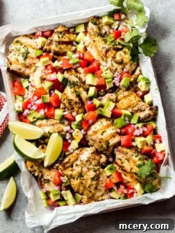 Overhead cilantro lime chicken with avocado salsa, a perfect summer meal idea.
