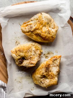 Close-up of a perfectly roasted bone-in chicken breast, golden and crispy.