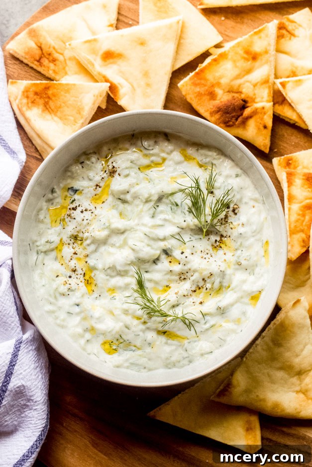Bowl of tzatziki yogurt sauce dip with fresh dill garnish
