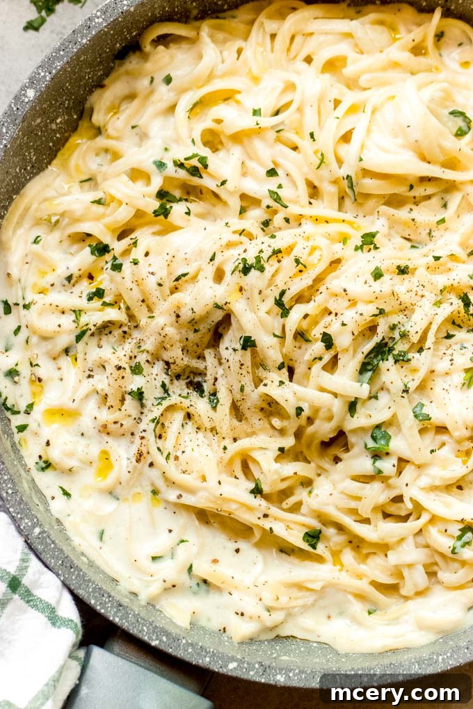 Close-up of creamy garlic sauce in a skillet, ready to be served over pasta.