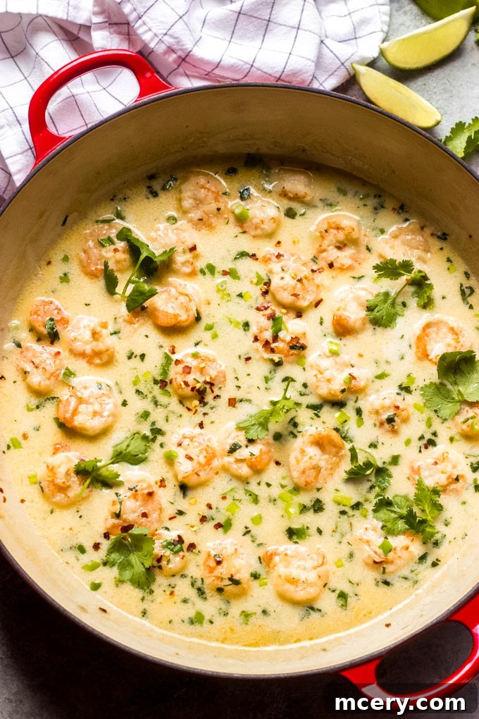 Velvety Coconut Shrimp Sensation 2 Creamy Coconut Milk Shrimp dish, garnished with fresh herbs, served over rice