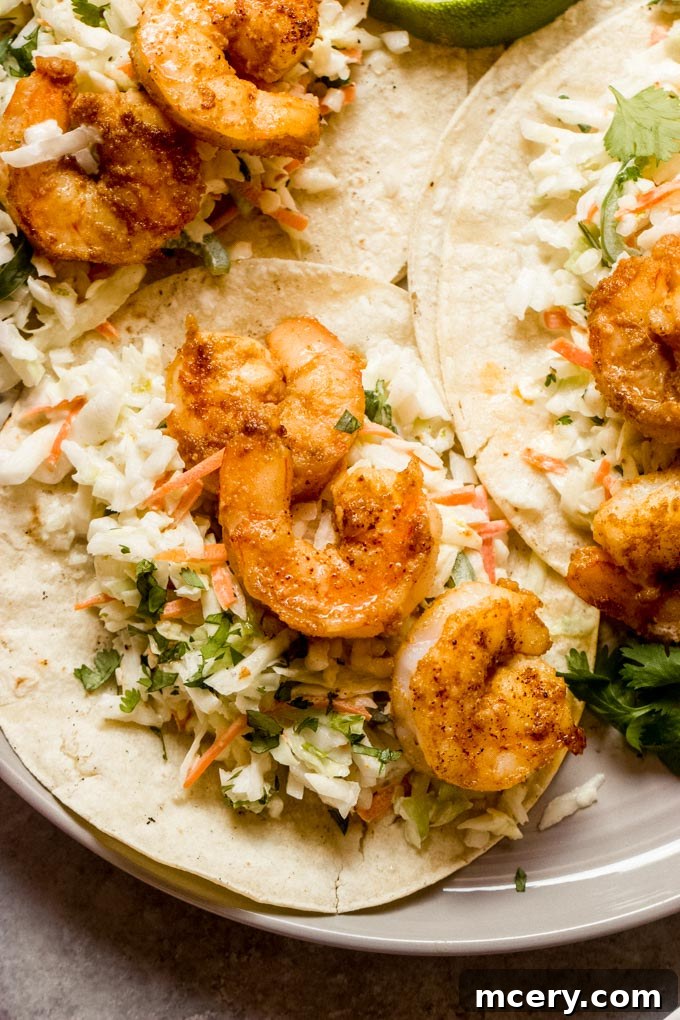 Fiery Shrimp Taco Fiesta 3 Close-up of a spicy shrimp taco with creamy slaw, showcasing its vibrant ingredients.