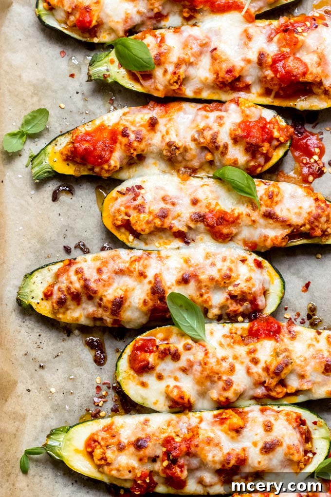 Delectable Chicken Zucchini Boats 9 Close-up overhead shot of bubbling hot chicken stuffed zucchini boats