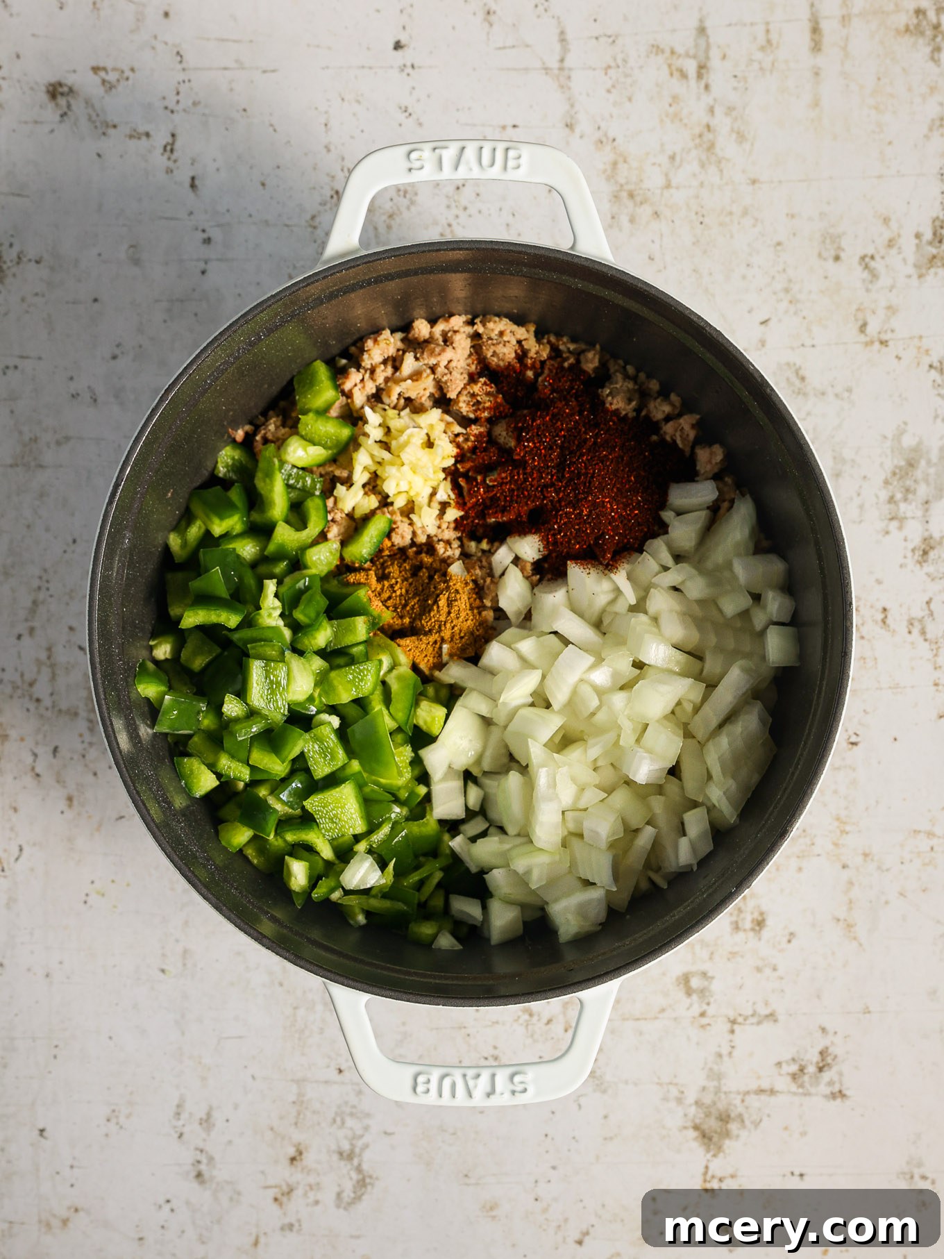 Hearty Three Bean Turkey Chili 4 Cooked ground turkey and vegetables simmering in a large pot, forming the flavorful base of the chili.
