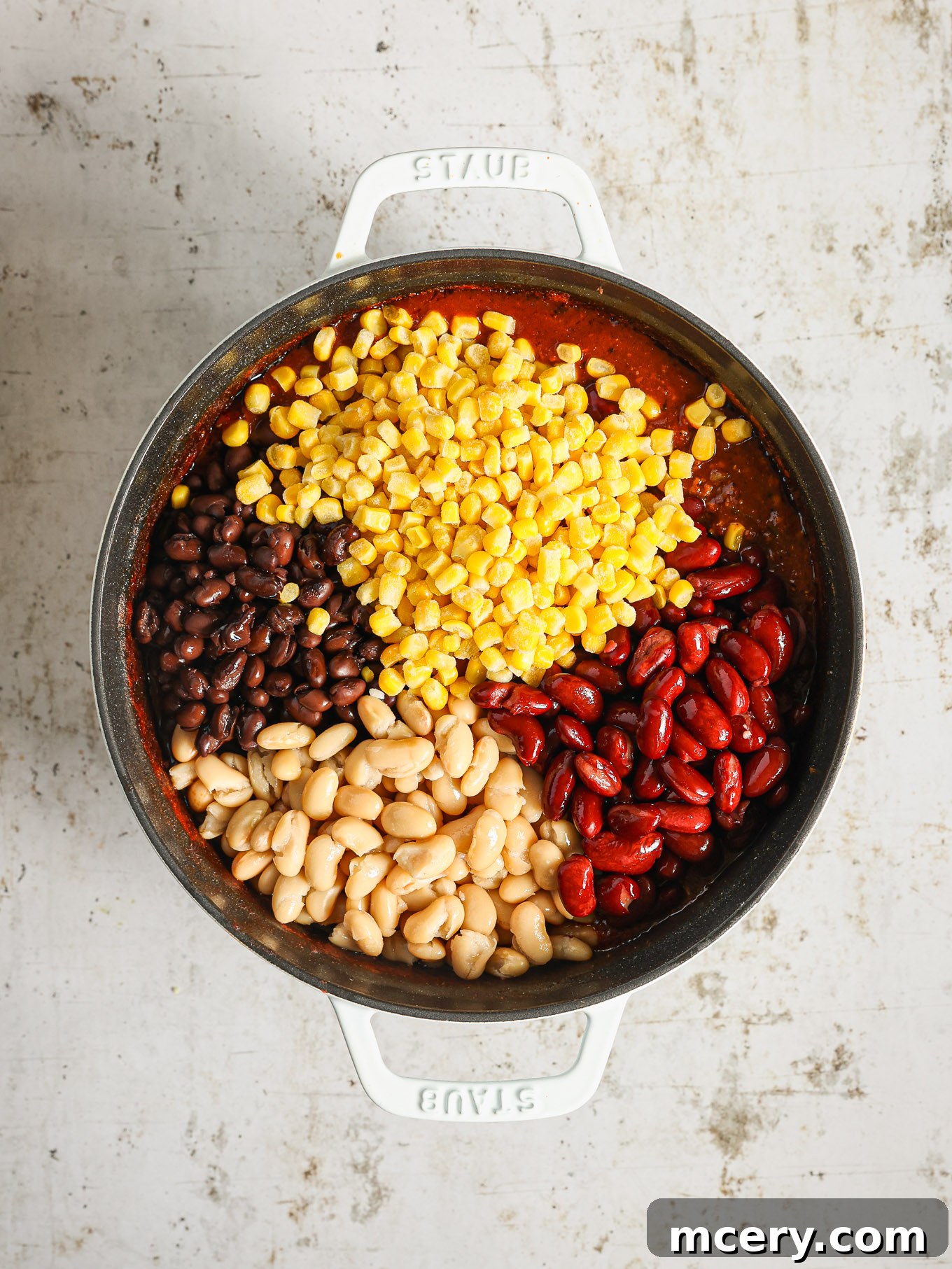 Hearty Three Bean Turkey Chili 7 Three types of drained and rinsed beans and frozen corn kernels stirred into the simmering chili, adding the final touches to the dish.