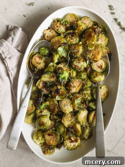 Roasted Brussels sprouts on an oval platter, perfectly caramelized and ready to serve.