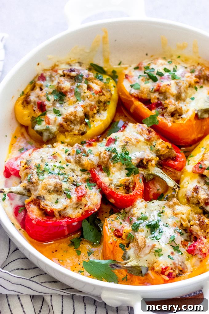 Stuffed peppers with sausage and rice in a baking dish