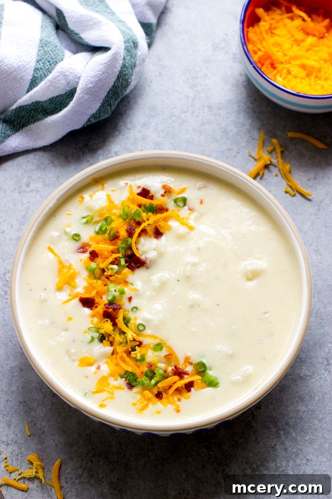 Quick Creamy Stovetop Potato Soup 2 quick and easy potato soup in a white bowl garnished with cheese, bacon, and green onions.