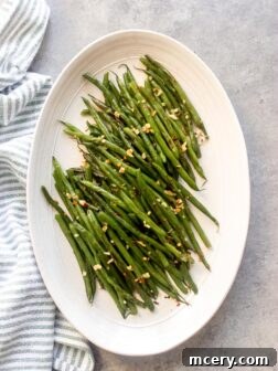 Spicy Asian green beans with a vibrant glaze in a serving bowl.