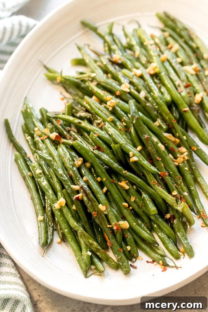 Sesame Garlic Green Beans 7 Close-up of Asian style green beans plated, showing the sweet and spicy glaze and slight char on the vegetables.