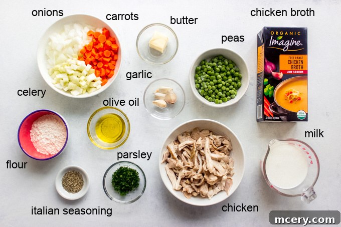 Fresh ingredients for crustless chicken pot pie, including vegetables, chicken, and seasoning
