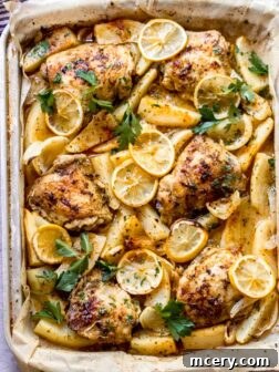 Zesty Lemon Herb Roasted Chicken and Golden Potatoes 10 Close up roasted chicken and potatoes in a baking pan