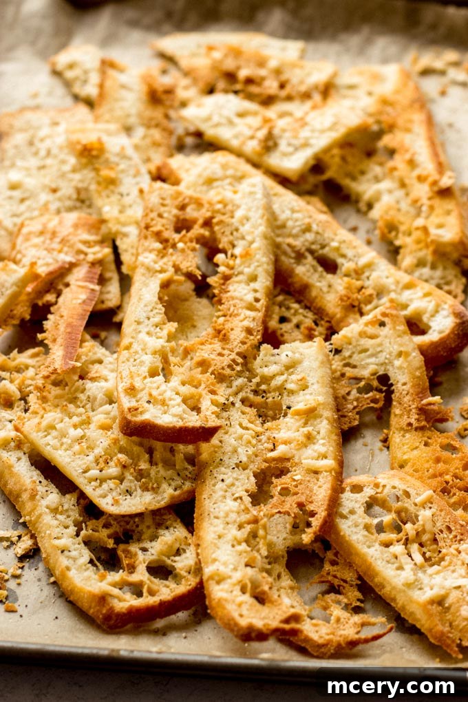Crunchy Bread Bites 7 Close up shot of golden Parmesan crisps on parchment paper, highlighting their delicious texture.