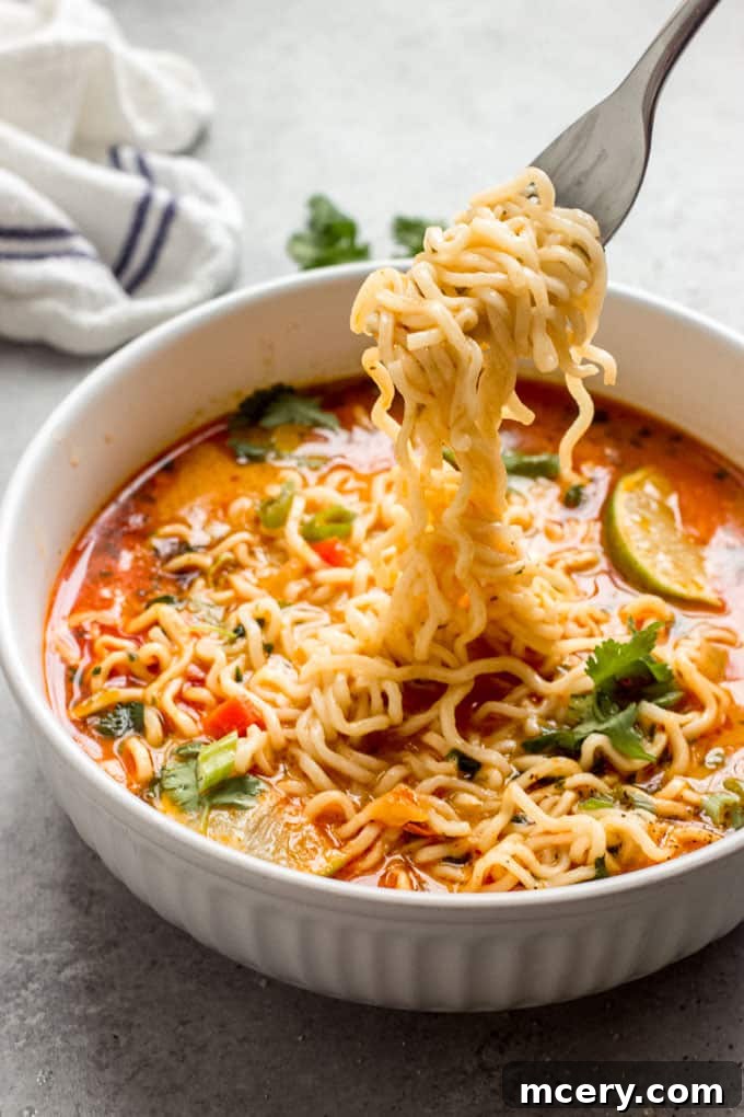 Vibrant Thai Red Curry Noodle Bowl 3 A steaming bowl of homemade Thai noodle soup with fresh ingredients