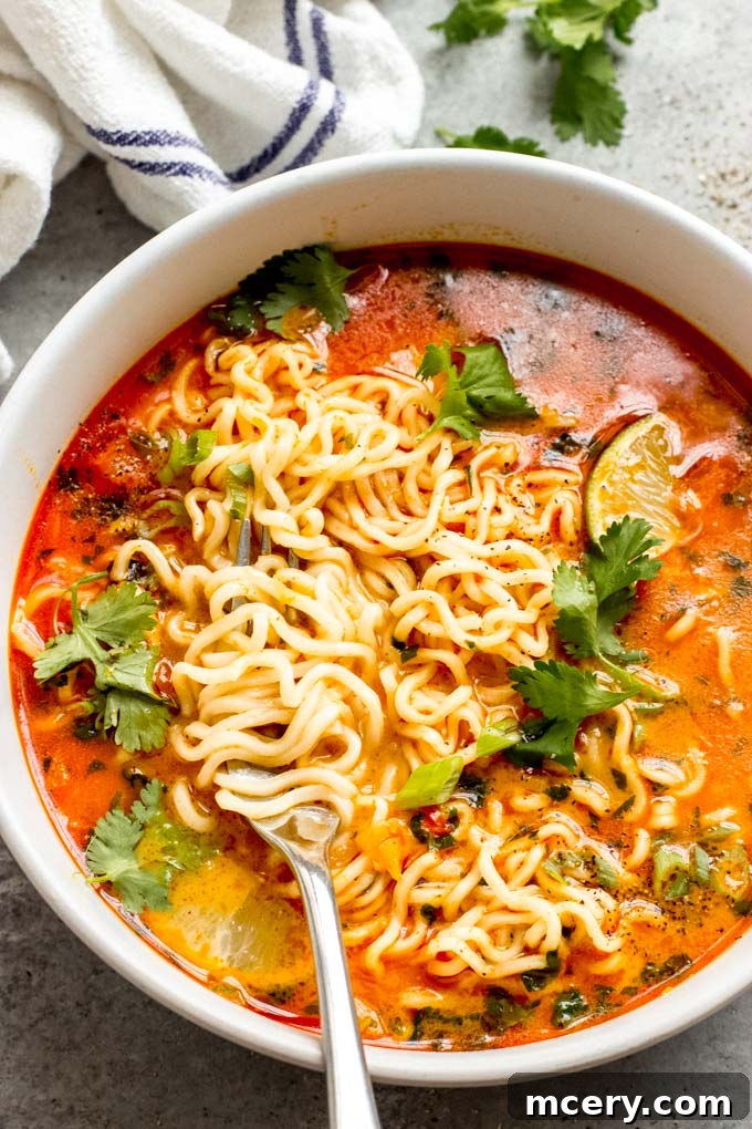Vibrant Thai Red Curry Noodle Bowl 8 Close-up of a serving of Thai curry noodle soup garnished with fresh cilantro